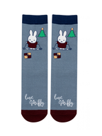 Miffy™ Christmas Socks in blue, with Miffy on her skis beside a Christmas tree and a stack of presents