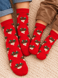 Hamish Christmas Socks worn by an adult and a child together, red with Hamish the Highland Cow in his Christmas holly